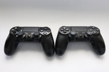 Two game joysticks close up, Modern black game controllers - ergonomic gaming accessories for console, game controllers on white background, joysticks on white background, gamepads