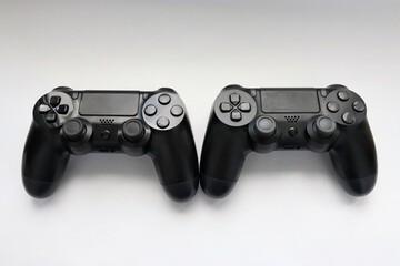 Two game joysticks close up, Modern black game controllers - ergonomic gaming accessories for console, game controllers on white background, joysticks on white background, gamepads