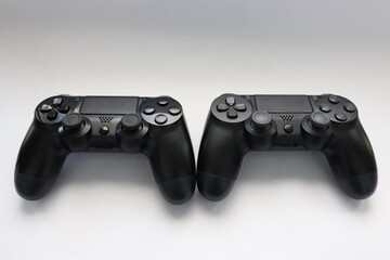 Two game joysticks close up, Modern black game controllers - ergonomic gaming accessories for console, game controllers on white background, joysticks on white background, gamepads