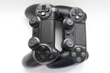 Two game joysticks close up, Modern black game controllers - ergonomic gaming accessories for console, game controllers on white background, joysticks on white background, gamepads © Alla