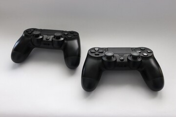 Two game joysticks close up, Modern black game controllers - ergonomic gaming accessories for console, game controllers on white background, joysticks on white background, gamepads