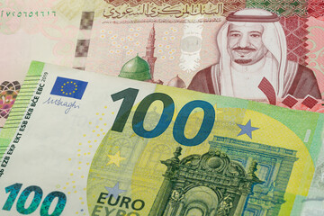 100 Saudi riyal and 100 Euro banknotes. International trade concept