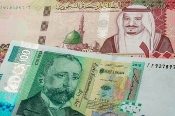 100 Saudi riyal and 100 Bulgarian lev banknotes. International trade concept
