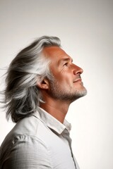 Obraz premium Idea of style for aging men. Modish men's mullet haircut - midlife arabian man with middle hair. Pure white solid background. A stylish and glowing male with a relaxed aura.