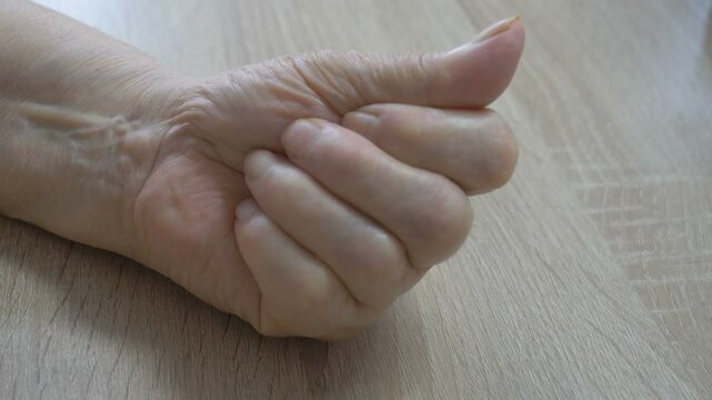 A pill to prevent heart disease in the hand of an old woman