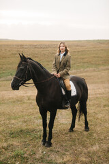 Woman Horseback Riding in Equestrian Outfit Across Open Countryside