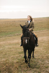 Woman Riding a Horse in a Scenic Open Grassland Area