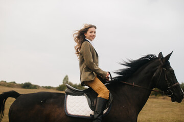 Woman Enjoying Horseback Riding in Rural Landscape on a Breezy Day