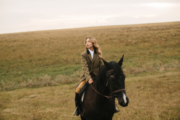 Young Woman Horseback Riding Across a Scenic Meadow Landscape