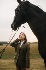 Elegant Woman in Tweed Jacket Next to a Horse in Scenic Landscape