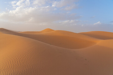 Strong wind blowing the loose sand in the Sahara Desert, Morocco, Africa.