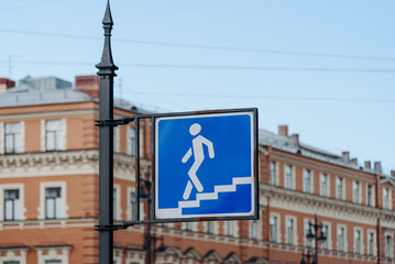 pedestrian crossing sign on pole on city street