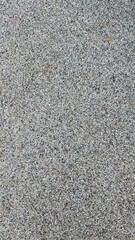 Rough asphalt surface light grey. Neutral minimal background.
