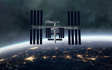 International Space Station Orbiting Earth at Night &mdash; The ISS floats above Earth&rsquo;s surface, lit by city lights below and flanked by glowing solar panels. A tranquil moment of science