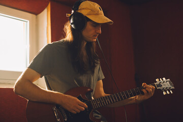 Musician playing electric guitar in recording studio