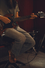 Musician playing electric guitar in recording studio