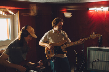 Musicians playing guitars in recording studio
