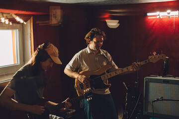 Musicians playing guitars in recording studio