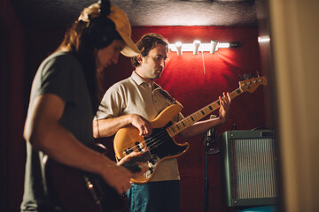 Obraz premium Musicians playing guitars in recording studio