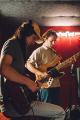 Obraz premium Musicians playing guitars and recording music in studio