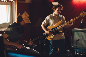 Obraz premium Musicians playing guitars and recording music in studio