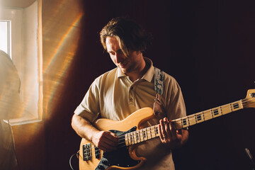 Obraz premium Musician playing bass guitar in recording studio