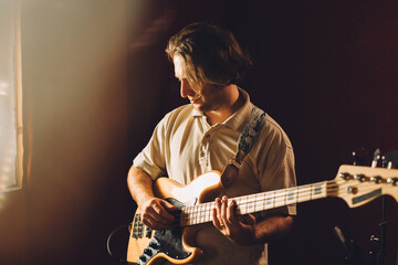 Obraz premium Musician playing bass guitar in recording studio