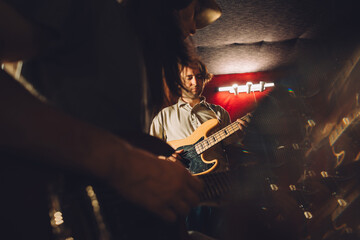 Musicians playing electric guitars in recording studio