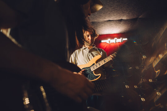 Musicians playing electric guitars in recording studio
