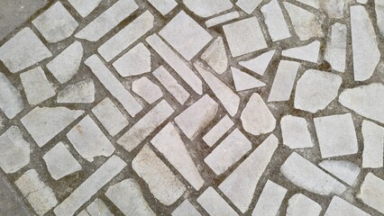 Stone sidewalk in close-up. Texture of marble mosaic. Random paving bricks. Stone pavement. Mosaic...