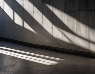 Parallel sunlight beams casting distinct patterns on a gray concrete wall and floor
