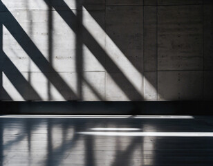 Parallel sunlight beams casting distinct patterns on a gray concrete wall and floor
