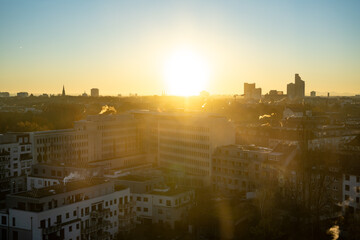Sunset and sunrise over Cologne city skyline with buildings and yellow blue sky.