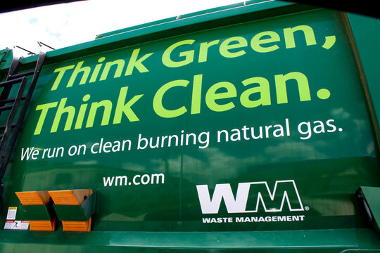 Waste Management garbage truck featuring environmental messaging promoting clean-burning natural gas. Taken July 2021 in Miami, Florida.