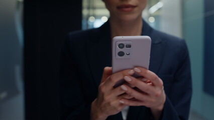 Businesswoman hands holding cellphone in vestibule closeup. Woman messaging