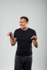 Playful Young Man Imitating a Dinosaur Pose and Laughing