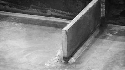 weld seam attaches a black metal part to another metal surface, metal welding industrial...