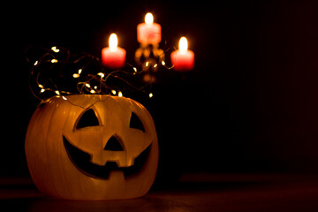 Halloween Pumpkin Lantern with Lights and Candles on Dark Background. copy space