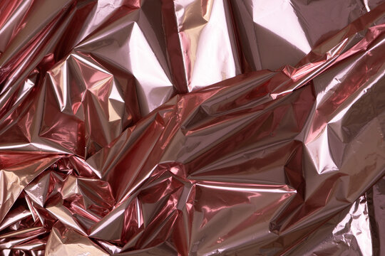 Crumpled rose gold foil as background, closeup view