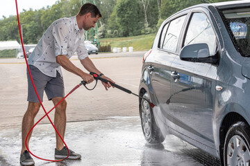 Car wash. Car cleaning foam soap bubbles. Spray water vehicle shine wet.