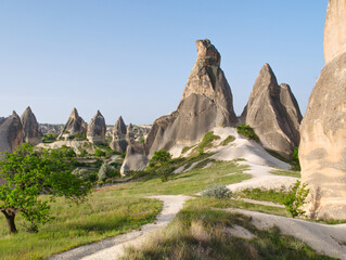 Rock formations in Cappadocia, Turkey under a clear blue sky.