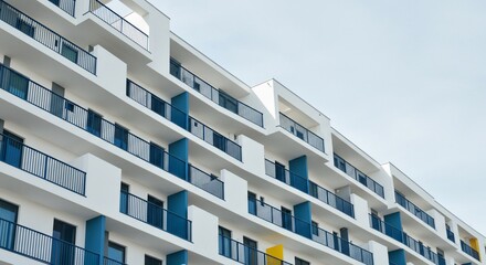 Fototapeta premium Modern White Apartment Building with Blue Balconies and Yellow Accent