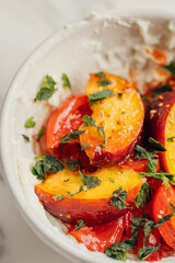 yellow peach salad with tomato, whipped cheese, mint