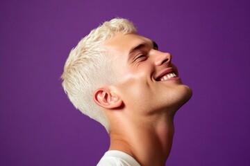 An elegant gentleman with short hair and a confident stance. Creative layout of style for aging men. Elegant men's buzz cut haircut - midlife white man with blond hair. Purple solid backgroun.
