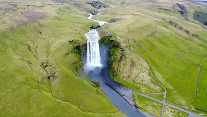 Aerial view of arrival to the spectacular Skogafoss waterfall situated in south Iceland. The waterfall  drops from a height of 60 meters.