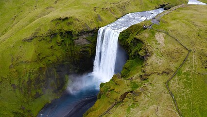 Obraz premium Aerial view of arrival to the spectacular Skogafoss waterfall situated in south Iceland. The waterfall drops from a height of 60 meters.