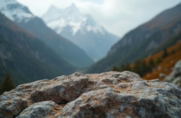 Close-up rock surface mountains. Blurred background mountain landscape with snow peaks, green slopes, valley. Scenic outdoor nature. Ideal for product display background. Promote travel, adventure,