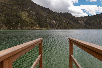 An exhilarating view from a wooden platform overlooking a clear lake, capturing the moment just...