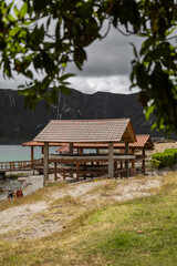 A charming wooden pier on the lake shore serves as a gateway for tourists boarding boats. Surrounded by peaceful water and nature, it offers a perfect start to lake tours.

