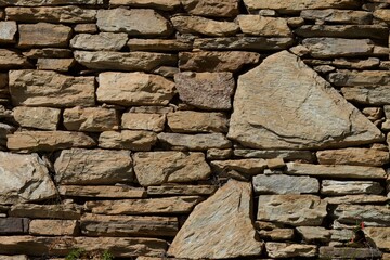 A wall made of stone blocks with a brownish color